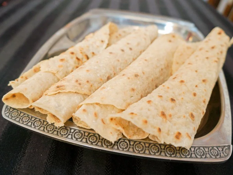 Delicately thin, hand-rolled lefse is a fixture on holiday tables in North Dakota, even in many non-Scandinavian households. Made from finely riced potatoes, the traditional Norwegian flat bread is cooked on a griddle until it forms a large, crepe-like sheet. North Dakotans smear it with butter and top it with white sugar, jam or jelly before rolling it up and eating it. Most families have their own (often ironclad) topping preferences. Those that don’t make their own lefse at home order from Freddy’s Lefse in West Fargo, where it’s been made by the same family since 1946.