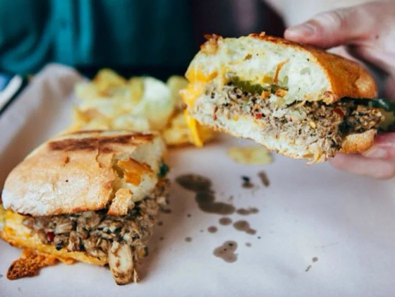 “Tuna salad” might make you think of drab canned tuna drowning in mayo. But at Portland’s Bunk, a temple to all things sandwich, tuna caught off the Oregon coast and packed in sustainable pouches is mixed with balsamic vinegar, olive oil, lemon juice, capers, red onion, basil and crushed red chiles, then served on a ciabatta roll and pressed with cheddar, mustard and housemade dill pickles. 