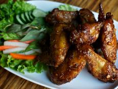<p>The heavy Oregon rain doesn't keep Chef Andy Rickers from cooking up some of his favorite dishes he brought home from his travels across Asia. Guy was all smiles as he ate the grilled boar with chile-lime garlic sauce and the spicy Vietnamese chicken wings topped with fried garlic.</p>