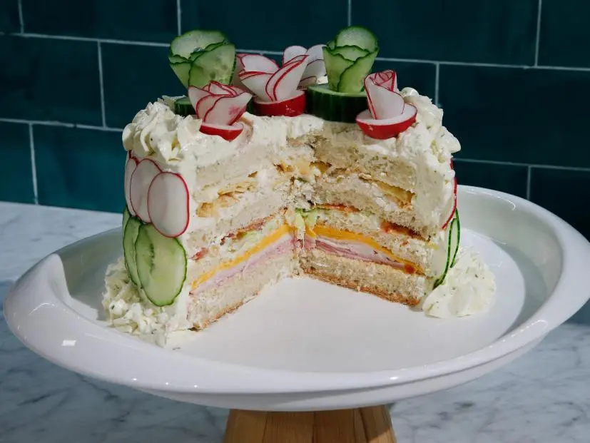 The Club Sandwich Cake is displayed, as seen on Food Network's The Kitchen Sink, Season 2.