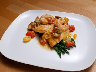 Mentor Anne Burrell's Pan Fried Flounder in Shrimp and Heirloom Tomato Pan Sauce with Pencil Asparagus dish is displayed, as seen on Food Network's Worst Cooks in America, Season 10.