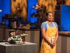 Contestant Jasmin Bell next to her completed dish, Chocolate Cake with Nutmeg and White Chocolate Filling and Chocolate Ganache, in the main heat, as seen on Food Network's Halloween Baking Championship Season 3