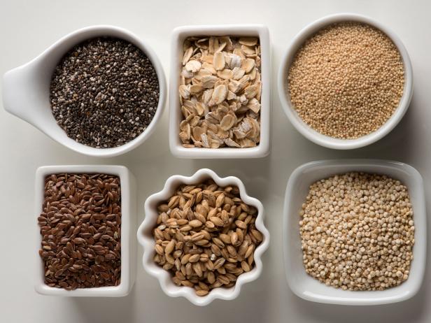 "Healthy cereals assortment  from top left clockwise linseed, chia, oat, amaranth seeds, quinoa, and barley.."