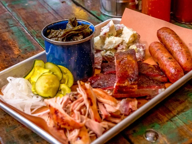 Boston has not historically been known for its barbecue, but Top Chef contestant Tiffani Faison made great strides when she opened Sweets Cheeks several years back. Based in Fenway, the restaurant is a casual and boisterous place to dine, with ribs, chicken and other smoky mainstays served on metal trays lined with butcher paper. Drinks arrive in mason jars. Faison’s biscuits, accompanied by honey butter, inspire an almost cult following, but the Texas-style barbecue is the star here. Heritage breed pulled pork, St. Louis pork ribs and chopped brisket can be ordered alone or in combo trays. Classic sides, like mac n’ cheese and collard greens, complement the meats. Try to save room for the outstanding butterscotch pudding, if you can.