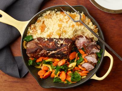 Food Network Kitchen’s Skillet Pork Tenderloin with Spiced Carrots and Couscous, as seen on Food Network.