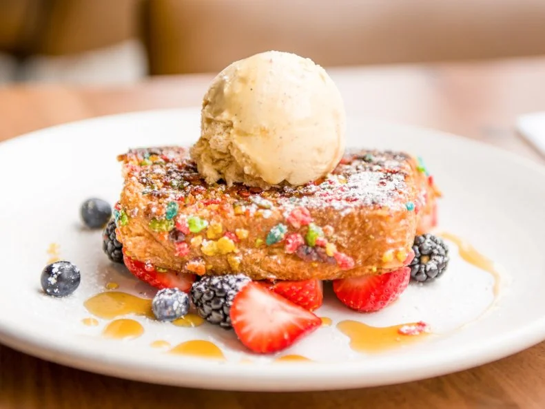 Cork & Pig Tavern is all about elevated comfort food. On weekends, Chef Felipe Armenta puts a next-level touch on brunch staples like eggs Benedict, huevos rancheros and French toast. In a French toast take that could be considered dessert, Armenta uses Fruity Pebbles to form a crisp crust around house-baked bread. Once golden-brown, the custardy slices are finished with a scoop of cinnamon ice cream and maple syrup.
