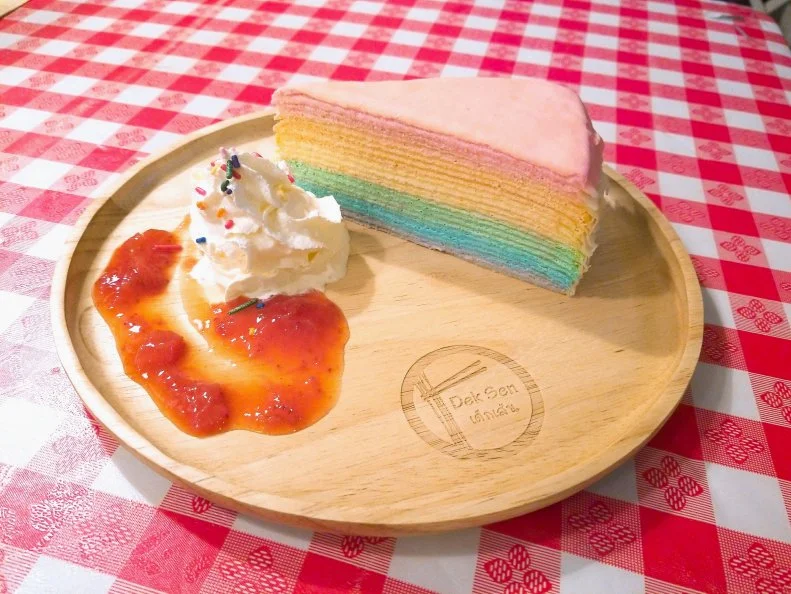 Mille-crepe cakes come in various hues depending on their flavor (vibrant green matcha or chocolate, for example), but the one at this Queens Thai restaurant Dek Sen features all six colors of the rainbow at once. Two pans are used to fire up 20 delicate tinted pancakes, which are then assembled into a cake with layers of homemade whipped cream. Each slice is plated with more cream and a strawberry sauce.