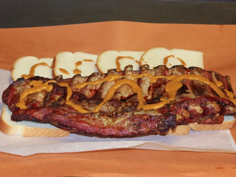 Florida may be best known for stone crabs and Cubanos, but as a big farming region, the Sunshine State has a long history of slow-cooked meat. Unlike other Southern areas known for ‘cue, the state has no defined barbecue regions. Individual barbecue joints here have unique styles and techniques that are all their own. Since 1957, Jenkins Quality Barbecue has been scorching palates with its unique hot mustard sauce. Slabs of ribs, half chickens and pork are smoked with oak in open brick pits, and the meat is laid atop slices of white bread or nestled inside a seeded bun and slathered with that tongue-tingling sauce. Spice neophytes, take heed: Jenkins offers a milder version of the mustard-based liquid that offers just as much flavor without the pepper.