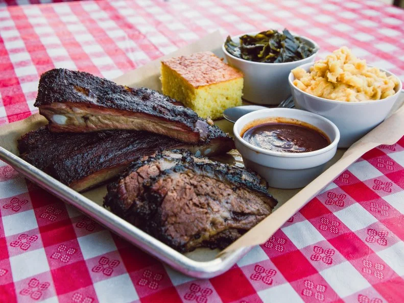 After eight years of slinging 1,000 pounds of meat a day from his Compton storefront, pitmaster Kevin Bludso closed up shop. Fortunately, the Texas native still has his fancy-booze-serving, sit-down locale in Fairfax, where guests sip barrel-aged old fashioneds while chowing down on ribs with spicy barbecue sauce. Following in his late grandmotherâ  s footsteps, Bludso seasons his meat with a special blend of spices, then smokes it low and slow for up to 14 hours with whole logs of hardwood charcoal. Brisket, the signature, is charred on the outside, juicy within. Pulled pork is smoky and moist. Texas red hots are crisp, with that ideal snap. No wonder health-conscious Angelenos are willing to consume the extra calories here.
