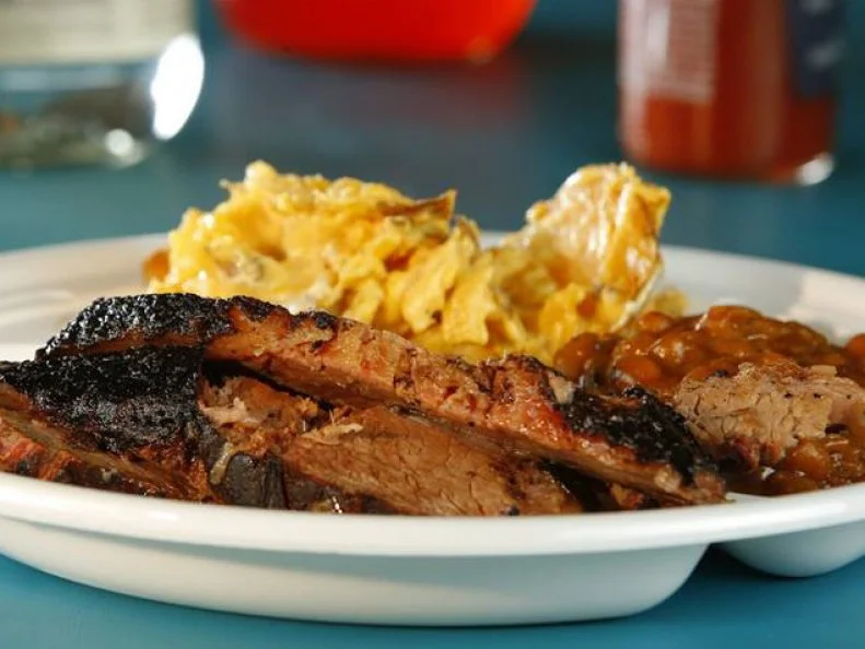 Bayport BBQ is in a league of its own. It is the quintessential family-owned-and-operated restaurant, with no employees other than Mom, Pop and the kids. The bar has a full liquor license, but the family chooses to serve only beer, wine and whiskey. Diners get their own food, through a buffet line that passes through the kitchen, where they pick up white-oak-smoked meats including chicken, pulled pork, spare ribs and sausage. The Texas-style brisket is the MVP, seasoned with a mix of spices and slow-cooked for 13 hours at slightly higher than normal heat (about 250 degrees F). Order it in sandwich form, topped with bread-and-butter pickles and coleslaw on housemade ciabatta-like bread.328 5th Ave N, Bayport, MN 55003; 651-955-6337