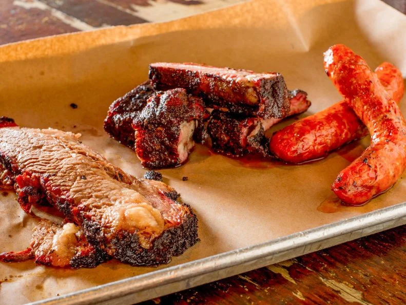 Barbecue has gone Brooklyn at this converted Williamsburg garage. Local craft beer and small-production spirits are served at the bar. All of the heritage-breed meat is 100 percent hormone- and antibiotic-free and is raised by small family farms. And just like the borough, itâ  s a melting pot of sorts, fusing different techniques into its own unique style of â  cue with picks like Duroc pork ribs and pulled pork, Berkshire pork belly and spicy sausage, and Free Bird half chicken as well as deli-inspired options like beef tongue pastrami and veal heart. The must-try is the Black Angus brisket, coated in the house dry rub, a mix of espresso, brown sugar, salt, garlic and spices, then slowly smoked until juicy and tender.