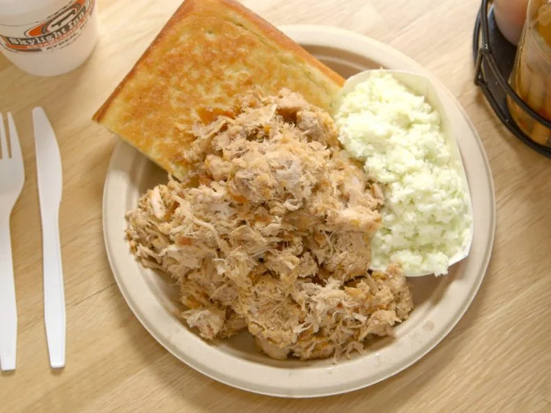 Eastern North Carolinaâ  s barbecue roots run deep. From Raleigh to the coast, locals have a long-standing tradition of smoking whole hogs over open pits, chopping up the white and dark meat, and mixing it all together with a white-vinegar-based sauce seasoned with just salt, pepper and some red pepper flakes. The Skylight Inn is the granddaddy of the regionâ  s barbecue restaurants. For more than two centuries, the family-run place has been serving fantastic whole-hog plates, which combine the crisp skin with the tender, juicy meat. Another delicious dish is the chopped pork sandwich served with cornbread and coleslaw.