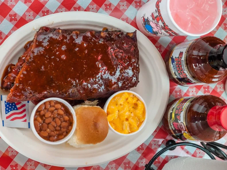 When many of these barbecue-circuit young guns were crawling around in diapers, Jon Olson was racking up — pun intended — awards. Back in 1980, Olson took home first place for ribs at the Wisconsin Association of Professional Meat Processors. He’s since won countless other distinctions at local and national competitions for his authentic wood-smoked ’cue. Olson uses only meat from locally raised butcher-quality hogs for his St. Louis spare ribs. Slabs are coated in his special spice rub, then cooked with low heat, high humidity and plenty of smoke for hours on end. When each order comes through, the slabs are finished on the grill and slathered with Olson’s sweet and smoky, full-bodied tomato-based sauce.
