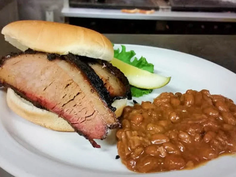 Try Southern-style smoked meats with Western ambiance at this family-owned bar, grill and barbecue joint. The laid-back restaurant is known for its wide range of hearty slow-cooked classics like beef brisket, kielbasa, pulled pork, turkey and pork ribs. However, the carnivorous options donâ  t stop there. Loaded beef ribs (basically prime left on the bone) are smoked, too, and the restaurant offers a special â  Wild Thangâ   menu with a mix of exotic meats. Sample rarer proteins like bison, ostrich, kangaroo, alligator, python and wild boar. Each entree order comes with a trip to the salad bar â   hey, even cowboys need a bit of fiber.