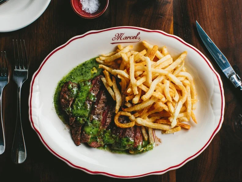 Marcel is easily known as one of Atlanta’s priciest meals, with devotees to Chef-Restaurateur Ford Fry’s bastion of steak forking over whatever it takes for dry-aged cote de boeuf, sole meuniere and precious bottles of French wine. However, sidle up to the dimly lit bar between 11 p.m. and 2 a.m. on Fridays and Saturdays for a late-night menu that’s a comparative bargain. The Frites Canard are topped with chicken gravy, duck confit and a fried egg ($10), a cheeseburger topped with crisp bacon clocks in at only $12, as does the soft crab omelet, accented with mushrooms and snipped chives. Order the hearty steak frites ($12) and a refreshing Kronenbourg 1664 Pale Lager ($7) for a taste of luxury without the sticker shock.  
