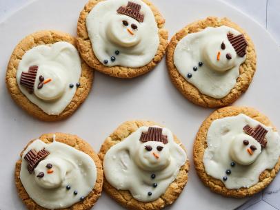 Description: Valerie Bertinelli's Melted Snowman Peanut Butter Cookies. Keywords: Vanilla Candy Melting Wafers, Peanut Butter Cookies, Marshmallows, Chocolate Chips, Orange Sprinkles, Mini Peanut Butter Cups.