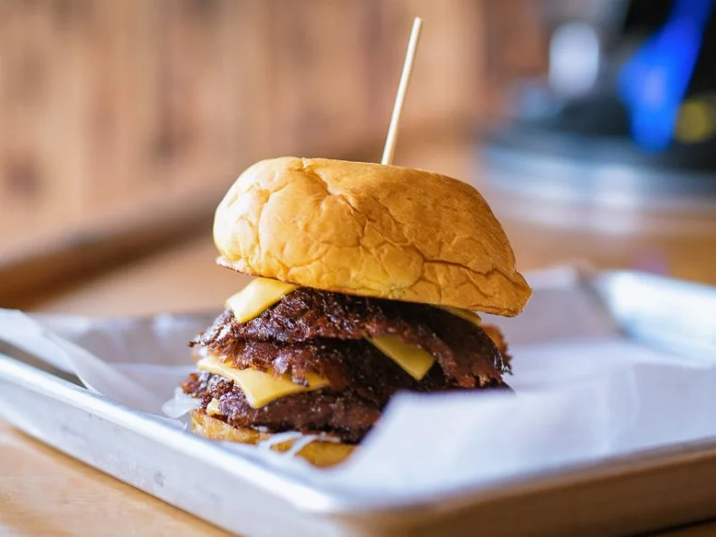 Chris McKenzie has long been known in the St. Louis food community for his dedication to pushing people to eat locally, thanks to his meat shares and CSAs. When he announced he would be opening a burger joint inside a local bar, Tamm Avenue Grill, diners didn’t know what to expect — but the industry pros did. The result is quite likely the best burger in all of St. Louis. McKenzie’s burger has not only all the marks of the best diner burgers, like the thin patty being cooked until ultra-crispy, but also a certain je ne sais quoi that comes from dry-aging. That’s right, this is a dry-aged diner burger, made from the best cuts of the animal. Simply put, it’s the best diner burger ever made.