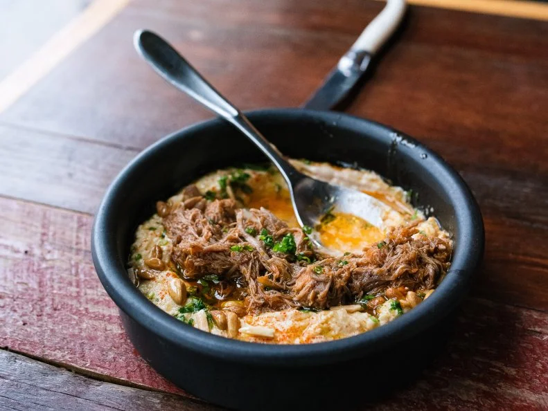 It’s hard not to feel cool inside Olio. Built inside a renovated 1930s gas station, this modern Israeli restaurant has both old-school charm and a contemporary edge, thanks to the design and decor. The food, too, alternates between modern and rustic — you can get a bowl of hummus with pita bread made in-house, or you can be a little fancier and go for something like the smoked trout tartine. What makes the restaurant perfect is that it’s great for any time of day, whether it’s a quick lunch, happy hour and snacks, or a romantic dinner out. Seriously, Olio’s bar program (especially the daily “spritz hour”) is not to be missed.