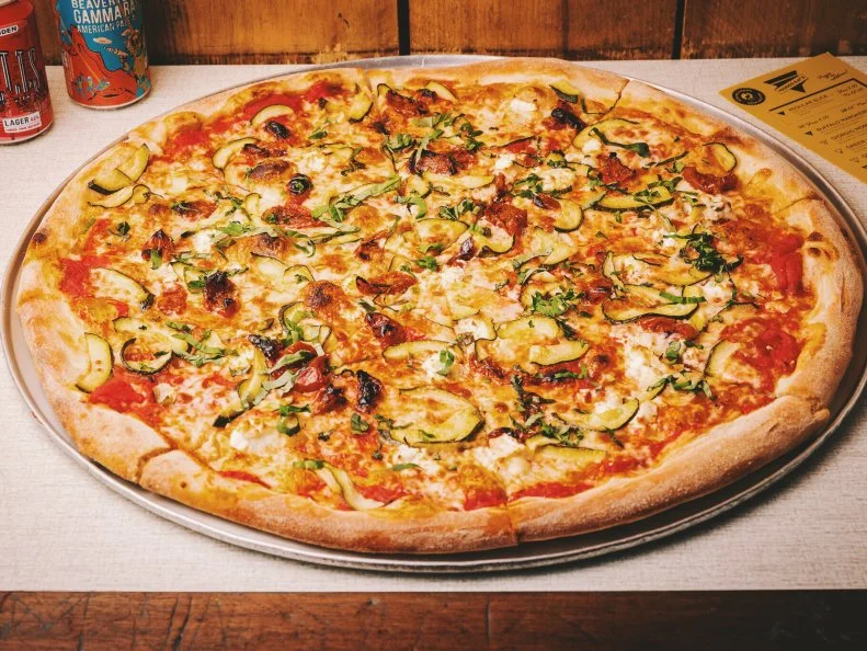 Pizza: good. Pizza with frozen margaritas: better. We'll be forever grateful to the genius that decided to pair the two at Voodoo Ray's, which enjoys a temporary home in Boxpark, a pop-up shipping-container shopping center (about as East London as it gets) with a delectable selection of food and drink offerings. Voodoo Ray's serves 22-inch, New York-style pizzas for a fair £4 a slice; pick and mix different flavors. The Green and White stars ricotta, spinach, pine nuts, mozzarella and pecorino; King Tubby teams fennel-and-chile sausage with kale, caramelized onions, vine cherry tomatoes, mozzarella and tomato sauce. If you've been out raving in Shoreditch, order the available-only-after-midnight Full Moon Slice: bacon dust, marinated tomatoes, mozzarella and Japanese mayonnaise.