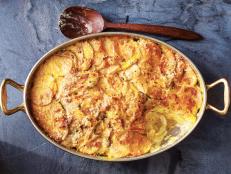When I travel, I bring a stack of food magazines to read for inspiration. On a particular cross-country flight, I was prepping for a new season of my TV show and saw a recipe for a parsnip gratin. I thought, "Well, parsnips are root vegetables. I love root vegetables in general. What if I just do a bunch of root vegetables all together in a gratin?" A few days later, I was basking in the creamy, cheesy glory of my latest creation. You'll do the same. You can slice your root vegetables with a knife, but I recommend using my favorite kitchen utensil, the mandoline, and then taking care to spread the thin slices evenly. This dish transforms a quartet of ordinary roasted root vegetables that might not otherwise cohabit the same baking dish into old-fashioned, crowd-pleasing comfort food. Later, you can ask, "When was the last time anyone asked for more parsnips?"