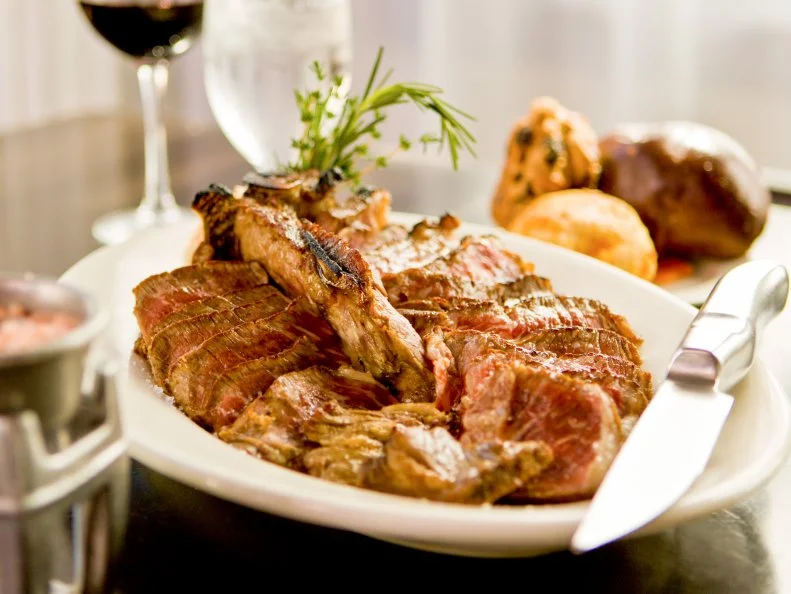 Prime 112 may feature all the usual steakhouse suspects — 16-ounce prime dry-aged filets, 48-ounce porterhouses for two, Japanese A5 Kobe — but its chef-driven New American menu is far more imaginative than the staid chophouses of yesteryear. Sauces include peanut hoisin, curry mayo and XXX hot sauce. Sides encompass whimsical riffs on classics like five cheese truffle “mac” and sweet potato-vanilla bean mash. Even with the fantastic fare, this place is best known for its meat-loving celebrity clientele. Alex Rodriguez, Jennifer Lopez, Queen Latifah and Drake have recently stopped in for a hunk of meat, but the restaurant has hosted a nearly endless list of A-listers since it debuted in 2004 including Justin Bieber, the Kardashians, Dwayne Wade and Gabrielle Union.

(Listing: http://www.foodnetwork.com/restaurants/fl/miami-beach/prime-one-twelve-restaurant)