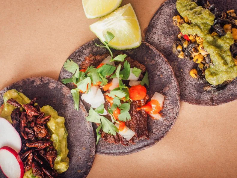 Miamians are obsessed with Taquizaâ  s tacos. Perhaps itâ  s due to the tortillas. Chef Steve Santana, a veteran of popular South Florida spots Eating House and Broken Shaker, uses ancient techniques to alkalize the responsibly sourced landrace blue corn used for his dough. That process, called nixtamalization, allows the body to absorb the rich nutrients in the kernels, and gives each tortilla a buttery, earthy flavor. Those impeccably crafted tortillas cradle an array of traditional ingredients, such as beef barbacoa, chicken and esoteric picks like grasshopper and beef tongue.(Listing: http://www.foodnetwork.com/restaurants/fl/miami-beach/taquiza-restaurant)