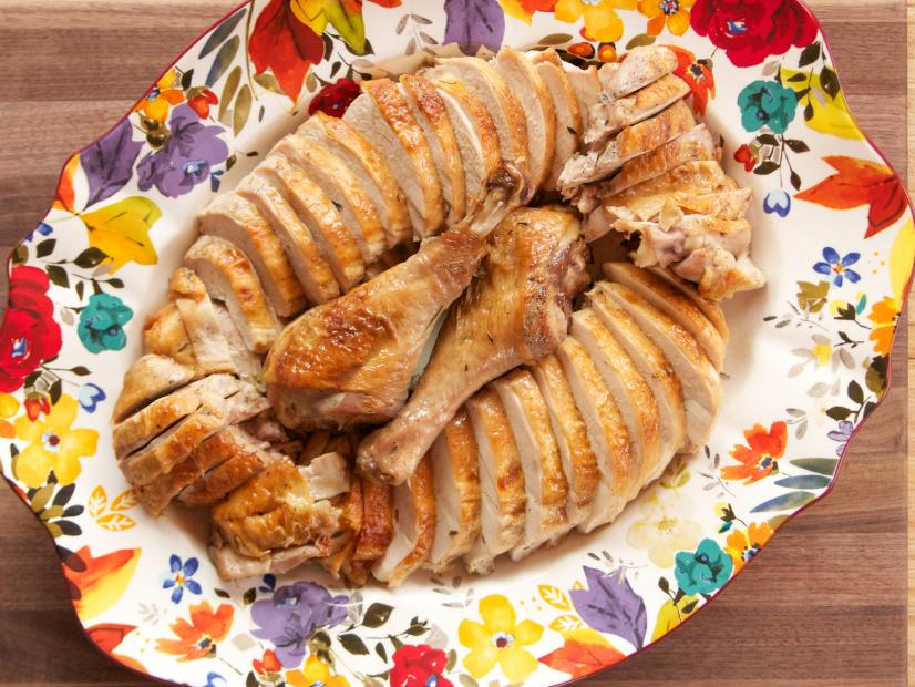 Overhead shot of carved Make Ahead Thanksgiving Turkey on floral platter