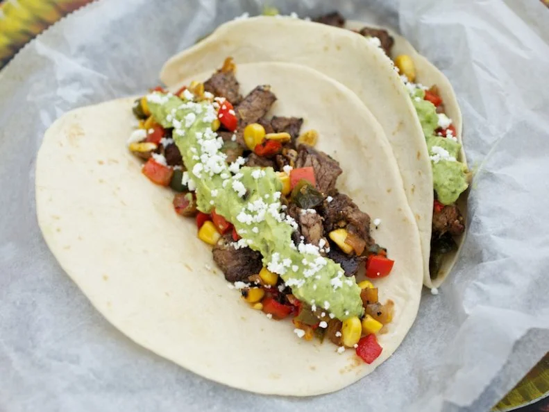 It's not an exaggeration to say that thousands of Austinites start their day with a TacoDeli breakfast taco. Their ambitious catering operation services most of the city's best coffee shops and hipper convenience stores with breakfast tacos, to the extent that it's tough to walk a few blocks without stumbling onto one of their Jess Specials (migas, cheese, avocado). Their morning menu is fantastic, but lunch is the best time to visit, thanks to a diverse menu of tacos bursting with fresh flavors and crisp textures. They're not boutique tacos by any means, but what separates TacoDeli from the rest is just-what-you-want fillings (avocado everywhere!) that don't melt into one mushy tortilla wrap. Try the cowboy taco (beef tenderloin, grilled corn, caramelized onions, guac), al pastor or mole pork, and don't miss out on specials like the Guacasabe Tuna. Also important to note, everything tastes even better thanks to the friendliest staffs in town.