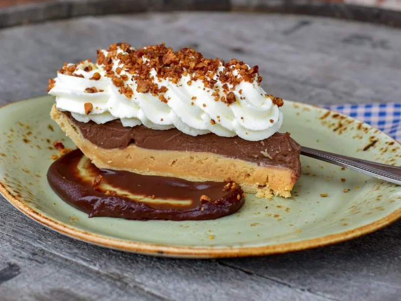 Combining her two most-beloved desserts – peanut butter cakes and chocolate cream pies – award-winning pastry chef Megan Garrelts created the ultimate old fashioned peanut butter chocolate pie to serve year-round. In the restaurant it’s topped with bittersweet chocolate sauce and a sprinkling of cocoa nibs.