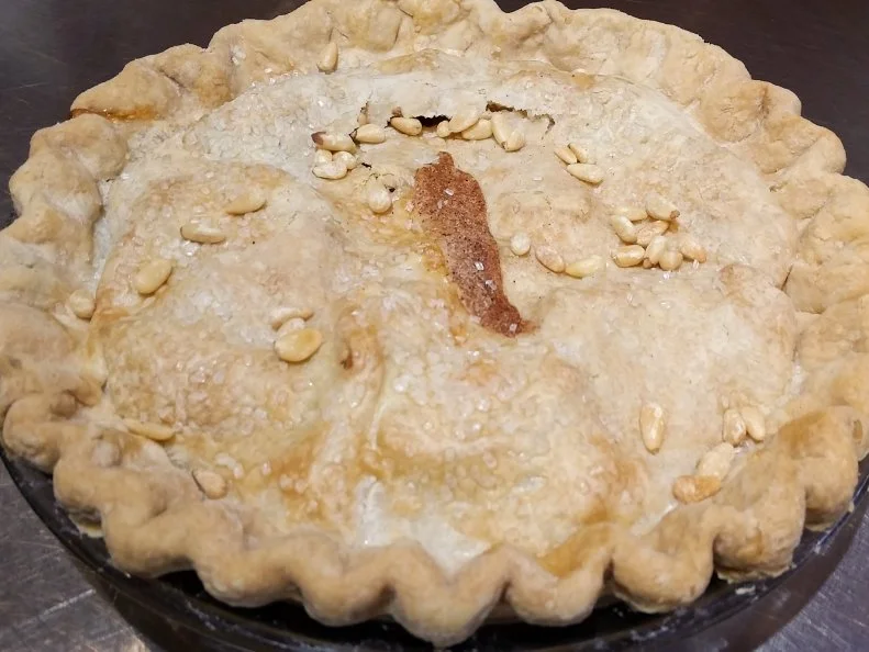 There is a little town in New Mexico called pie town that has become known for its pies. History recalls the town as a place that was a common rest stop. The owners of Pieoneer agree, having stopped on their own road trip and never continued on. Their pie bar is full of delicious pies including the tart New Mexico Apple pie made with green chiles and pine nuts, the dish has savory and spicy elements not often found in an all-American apple pie.