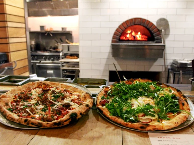 Any restaurant can have beer on tap. But what other restaurant also has Onyx Coffee and cocktails ice cold and ready to be dispensed out of a selection of taps at its bar? This friendly pizza parlor combines high-heat wood-fired oven creations (pizzas, flatbreads and the like) with Southern favorites and lots of cold beverages.