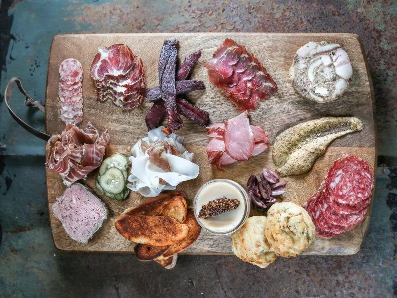 Chef Anthony Gray loves his meat, and Bacon Bros. Public House has given him a perfect place to ply his self-taught tasty trade. The place has a Powered by Bacon mission statement and a large curing room with a viewing window, but Gray’s claim to fame is his picturesque charcuterie and meat boards. Sold by the ounce, they feature all kinds of meats, pâté and rillettes, and are garnished with beer mustard made with local beers, dill pickles, olives and cheddar thyme biscuits made from scratch. But don’t overlook the snacks (think deviled eggs, pimento cheese and bacon caramel popcorn), salads, sandwiches, made-daily BBQ options (until they’re gone), classic South-leaning entrees (like catfish or shrimp and grits) and oh-so-Southern sides.