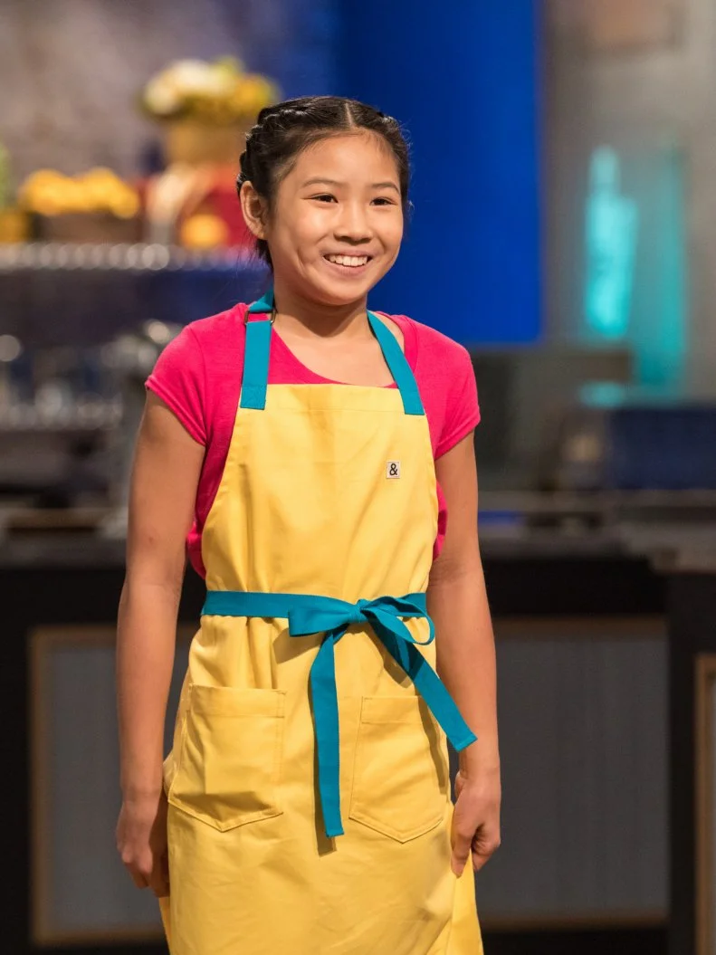 Contestant Linsey Lam presents her cookie cake dish from the main heat challenge to the judges, as seen on Food Network's Kids Baking Championship Season 4