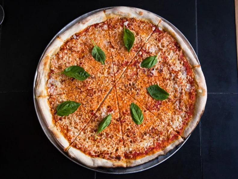This Williamsburg shop looks like your average corner pizzeria; however, it certainly doesn’t sidestep its superlative title. Roberta’s veteran Frank Pinello debuted the neighborhood joint in 2010 as an ode to his Bensonhurst roots, Sicilian heritage and love of New York’s pizza tradition. He uses a century-old wood-burning oven to create classic chewy and slim round pies as well as rectangular grandma pies with a snappy olive oil-infused crust. Like your traditional pizzeria, the menu here is simple with choice of white or red 20-inch pies and slices with your pick of toppings including Salumeria Biellese pepperoni, Pat LaFrieda short rib and brisket meatballs, anchovies, pickled veggies and Calabrian chile.