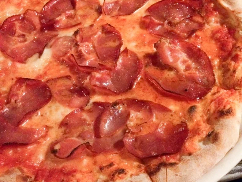 Set in a nondescript industrial section of Ridgewood in an unmarked former brewery, Houdini Kitchen Lab requires a certain navigational prowess. Given its out-of-the-way location and creative pizzas, it draws comparisons to Roberta’s, just a few subway stops west. The wood-fired pies are sort of like a Neapolitan-NYC hybrid, ultrathin, with top-notch ingredients. The Queen Pizza ups the ante on the regular Margherita with house-made stracciatella. The Habanera, layered with thin strips of cured pork and mouth-tingling chile oil is ideal for heat seekers.