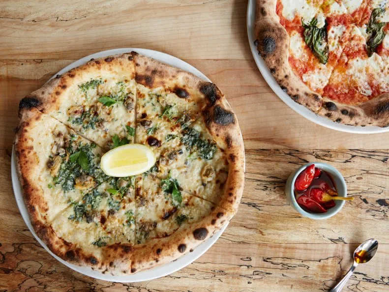When this Neapolitan-inspired pizzeria opened in early 2016, it was nearly impossible to score a reservation at a normal dining hour, and it can still take weeks to nab a table during primetime. Run by the team behind lively nouveau Italian hotspot Charlie Bird, this sophomore effort is the ideal combination of cool ambience, well-curated Italian wines and ambitious pies. Pliant wood-fired, thin-crust dough is elevated in compositions like the Diavola (hot pepper, mint and Neapolitan salami) and the garlicky Littleneck Clam.