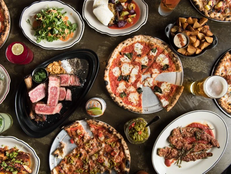Speedy Romeo’s is not your average NYC pizzeria. Chef-Owner Justin Bazdarich crafts thin-crust, Neapolitan-like wood-fired  that combine New American flavors from his hometown of St. Louis with Italian techniques and a bit of New York flair, leading to toppings like Katz’s Deli pastrami from Manhattan, and Missouri’s beloved provel cheese. The Dick Dale combines Hawaiian and European flavors, with bèchamel, speck, pineapple, St. Louis-style provel cheese and grilled scallions. At the new Lower East Side outpost, Bazdarich honors the neighborhood’s Jewish roots in the Paul’s Boutique, an everything bagel crust layered with dijon bèchamel, fontina, 1000 island dressing, smoked red kraut and pastrami.