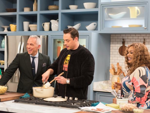 Katie Lee, Geoffrey Zakarian and Sunny Anderson watch as Jeff Mauro stirs buffalo Mac & Cheese, as seen on Food Network's The Kitchen.