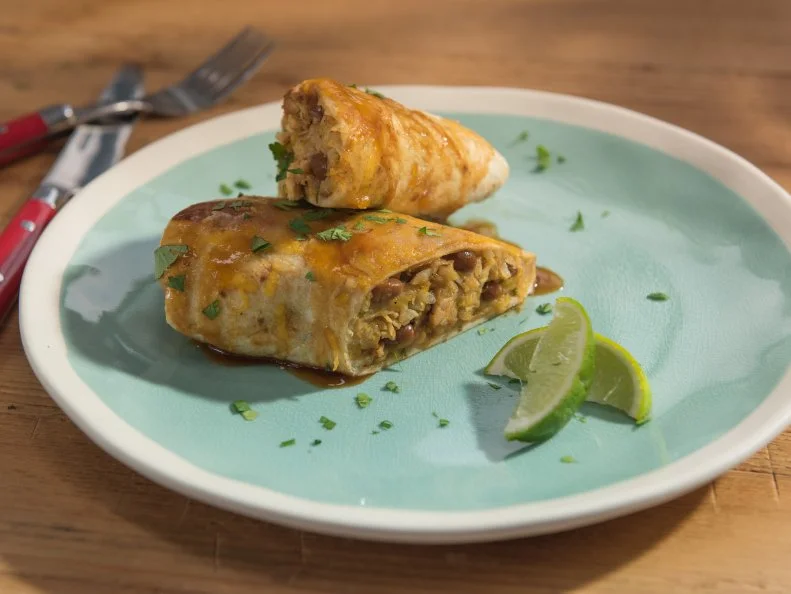 Sunny Anderson and Katie Lee mix together the ingredients for a honey chipotle chicken burrito, as seen on Food Network's The Kitchen.