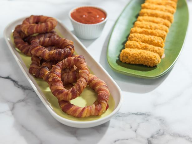 Bacon-wrapped onion rings and cereal-coated mozzarella sticks, as seen on Food Network's The Kitchen.