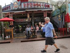 Host Guy Fieri outside Guy Fieri's Playa Del Carmen Kitchen and Bar in Centro, Playa Del Carmen, Mexico as seen on Food Network's Diners, Drive-Ins and Dives episode 2606.