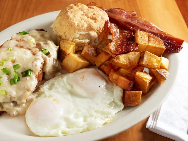 Elizabeth's Country breakfast with smothered pork loin, potato and side of praline bacon