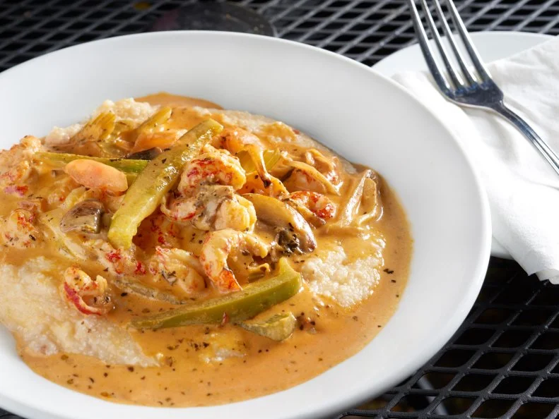 Acadia Crawfish & Grits our original -sauteed crawfish tails and the trinity over creamy creole grits