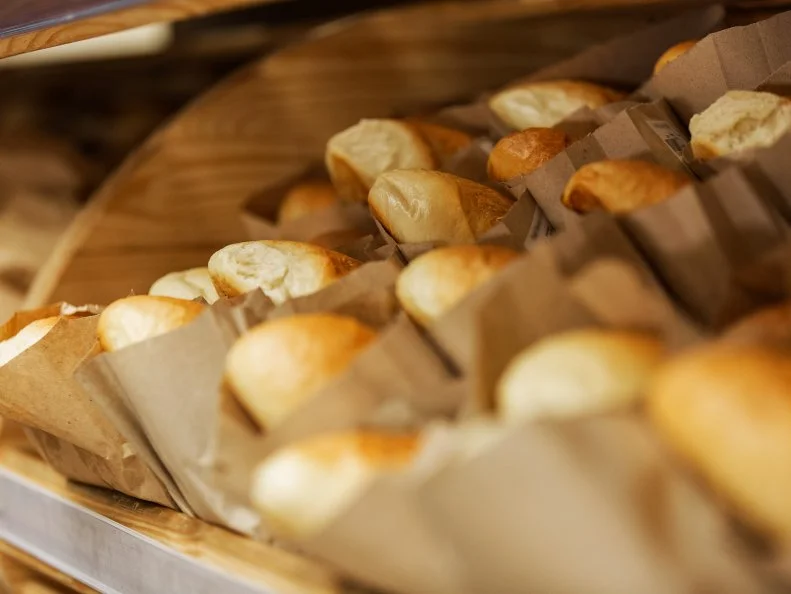 At the bakery. Shelf with loaves of white bread