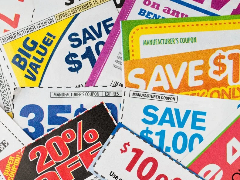 Large stack of money saving coupons.