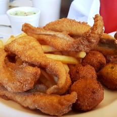 Fried catfish and hushpuppies with fries at The Shack in Jessieville, Arkansas as included in Arkansas's Most Iconic Eats for FoodNetwork.com