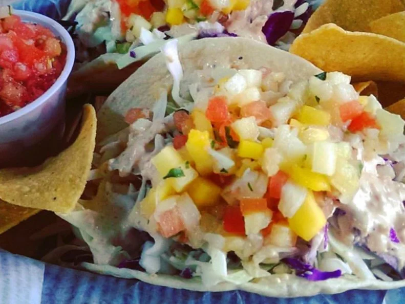 Throughout the summer months, Floridian's biggest concern is keeping cool, but their second-biggest might be figuring out ways to use up all the excess mangoes that bomb the streets. Like many chefs and home cooks, Jimmy Hula's incorporates the sweet fruit into a savory condiment, mango salsa. That sweet and tart tropical mix is the ideal topping for fish tacos, a Floridian accent for the Southern California snack. The Central Florida chainlet offers sustainable whitefish that's grilled, blackened or fried, tucked into grilled flour tortillas and topped with varying combinations of toppings. Six signature tacos are on the menu, half of which come with the shop's original mango-pineapple salsa.