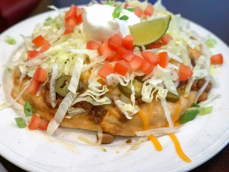 Members of the Las Vegas Paiute tribe typically offered fry bread tacos only at special events like pow wows and rodeos. That changed in 1995 when the tribe opened the gorgeous Las Vegas Paiute Golf Resort northwest of Las Vegas. Originally a seasonal special, the addictive tacos proved so popular that theyâ  re now on the permanent menu, fried in a cast iron pan and topped with housemade chili, shredded cheese, lettuce, tomato, sour cream and house salsa.