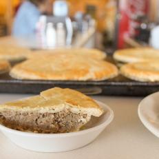 French Canadian immigrants brought many recipes to Vermont, but Quebecois meat pie, called tourtiere, stands out. Families baked dozens for end-of-year celebrations that lasted through the night. The two-crusted pies are usually filled with ground beef and pork, onions, mashed potato, cinnamon, and cloves. Quality Bake Shop in Essex Junction has made them for more than 30 years, based on a family recipe.