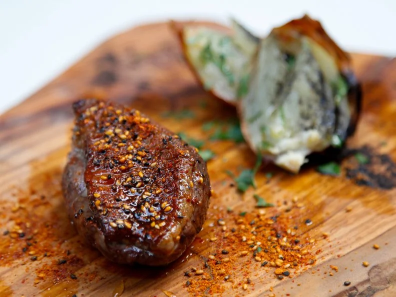 This stylish spot in trendy Daikanyama has the look and feel of a modern yakitori restaurant, featuring counter seating surrounding an open kitchen with an impressive stone grill. But skewered chicken is nowhere to be found on Chef Noritaka Kashimura’s diverse menu of Japanese-inflected Italian fare. Charcoal-grilled porchetta, which comes in meaty slabs, is Kashimura’s signature, though the slow-roasted duck breast is the runaway star. Rubbed with a mix of sansho (Japanese pepper), charred onion and fennel powder, then lightly brushed with honey, the dish balances savory, spicy and sweet notes in near equal measure. Seasonal pasta dishes, such as homemade gnocchi in tarragon-butter sauce topped with ikura salmon roe, pair nicely with the selection of natural wines.